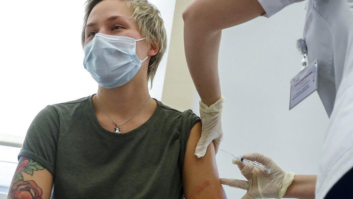 A medical worker moves a box of Russias Sputnik V coronavirus vaccine out from a refrigerator prior to administering a vaccination in Moscow, Russia, Saturday, Dec. 5, 2020. Thousands of doctors, teachers and others in high-risk groups have signed up for COVID-19 vaccinations in Moscow starting Saturday, a precursor to a sweeping Russia-wide immunization effort. (AP Photo/Pavel Golovkin)