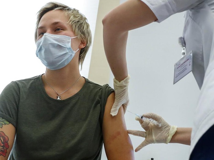 A medical worker moves a box of Russias Sputnik V coronavirus vaccine out from a refrigerator prior to administering a vaccination in Moscow, Russia, Saturday, Dec. 5, 2020. Thousands of doctors, teachers and others in high-risk groups have signed up for COVID-19 vaccinations in Moscow starting Saturday, a precursor to a sweeping Russia-wide immunization effort. (AP Photo/Pavel Golovkin)