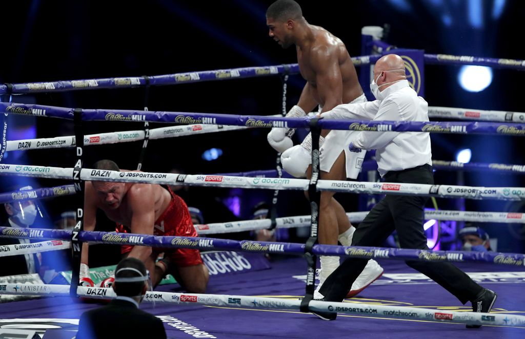 LONDON, ENGLAND - DECEMBER 12: The referee stops the fight as Anthony Joshua knocks down Kubrat Pulev during the IBF, WBA, WBO and IBO World Heayweight Title fight between Anthony Joshua and Kubrat Pulev at The SSE Arena, Wembley on December 12, 2020 in London, England. A limited number of fans (1000) are welcomed back to sporting venues to watch elite sport across England. This was following easing of restrictions on spectators in tiers one and two areas only. (Photo by Andrew Couldridge - Pool/Getty Images)
