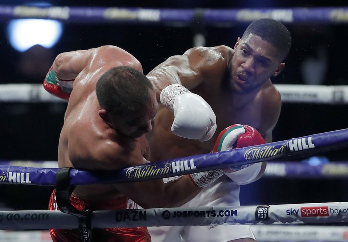 World Heavyweight boxing champion Britains Anthony Joshua lands a blow on challenger Bulgarias Kubrat Pulev during their Heavyweight title fight at Wembley Arena in London Saturday, Dec. 12, 2020. (Andrew Couldridge/Pool via AP)
