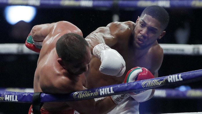 World Heavyweight boxing champion Britains Anthony Joshua lands a blow on challenger Bulgarias Kubrat Pulev during their Heavyweight title fight at Wembley Arena in London Saturday, Dec. 12, 2020. (Andrew Couldridge/Pool via AP)