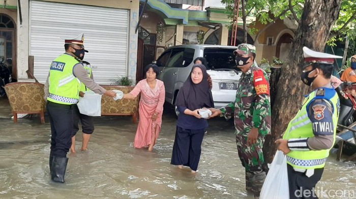 Jalan Benjeng di Gresik masih dilanda banjir luapan Kali Lamong. Satlantas Polres Gresik melakukan pengalihan arus.