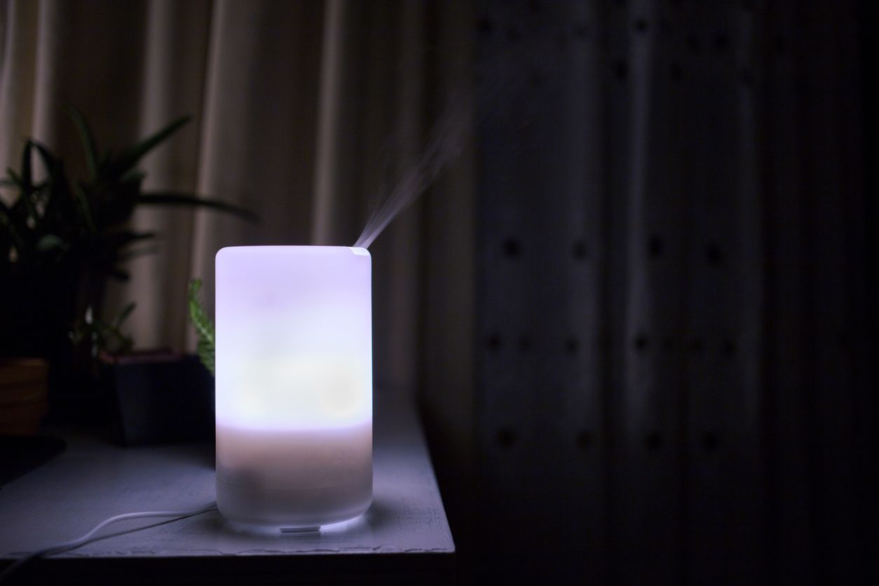 Diffuser Essential oils diffuser glowing in the dark while diffusing aromatherapy mist