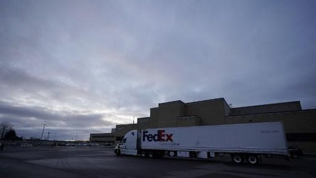 LANSING, MI - DECEMBER 13: A UPS worker hooks a UPS truck to a trailer containing shipments of the Pfizer And BioNTech COVID-19 vaccine at the Capital Region International Airport on December 13, 2020 in Lansing, Michigan. The first doses of the coronavirus (COVID-19) vaccine will be distributed to all 50 states.   Rey Del Rio/Getty Images/AFP