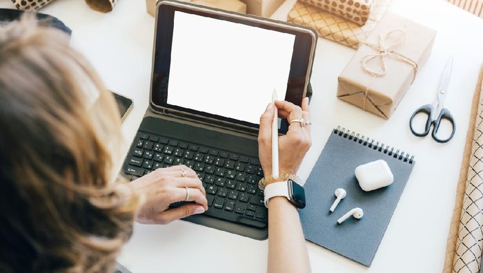 Creative manager draws a design on a laptop monitor screen. Cozy working office desk close-up. Mockup