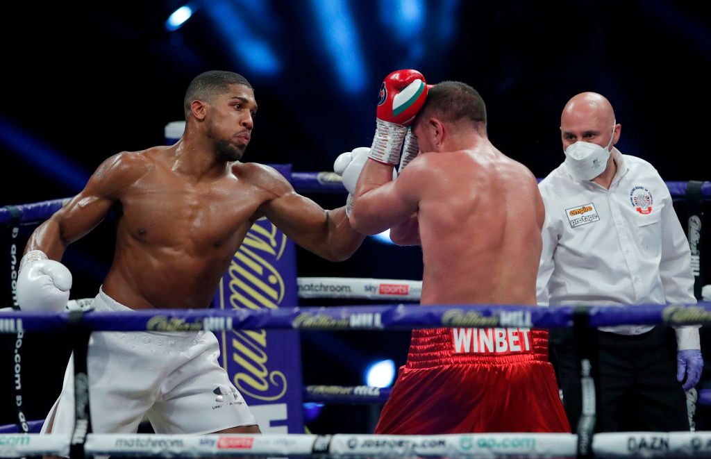 LONDON, ENGLAND - DECEMBER 12: Anthony Joshua punches Kubrat Pulev during the IBF, WBA, WBO and IBO World Heayweight Title fight between Anthony Joshua and Kubrat Pulev at The SSE Arena, Wembley on December 12, 2020 in London, England. A limited number of fans (1000) are welcomed back to sporting venues to watch elite sport across England. This was following easing of restrictions on spectators in tiers one and two areas only. (Photo by Andrew Couldridge - Pool/Getty Images)