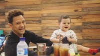 Bukti kedekatan Lucky Perdana dengan anaknya. Baik Lucky Perdana maupun anaknya sama-sama ceria, berpose dengan es teh manis di depannya.  Foto: Instagram @_luckyperdana