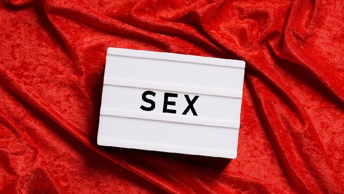 sex or sexuality abstract concept without people, word on lightbox or light box sign on red velvet background