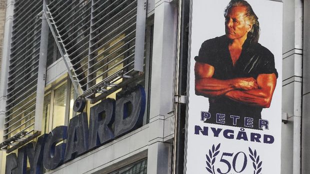 A sign bearing the likeness of Peter Nygard is displayed outside his Times Square headquarters, Tuesday, Feb. 25, 2020, in New York. Federal authorities on Tuesday, Feb. 25, 2020, raided the Manhattan headquarters of the Canadian fashion mogul Peter Nygard amid claims that he sexually assaulted and trafficked dozens of teenage girls and young women. (AP Photo/John Minchillo)