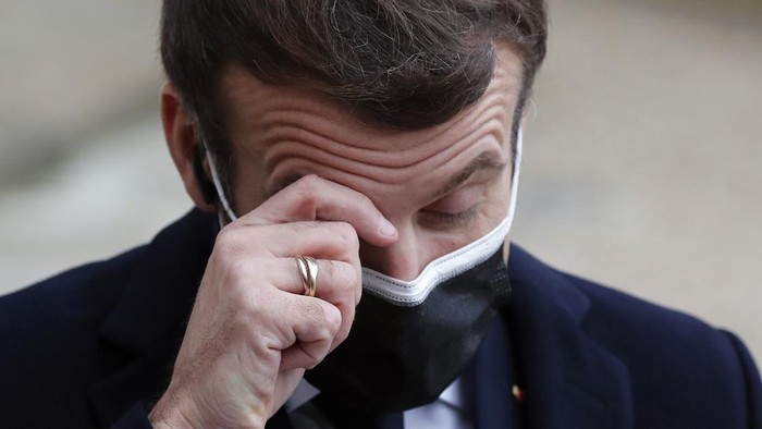 French President Emmanuel Macron reacts as he listen to the speech of Portuguese Prime Minister Antonio Costa, Wednesday, Dec. 16, 2020 in Paris. French President Emmanuel Macron has tested positive for COVID-19, the presidential Elysee Palace announced on Thursday. (AP Photo/Francois Mori)