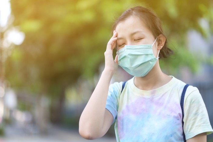 Asian girl with surgical mask felling dizziness