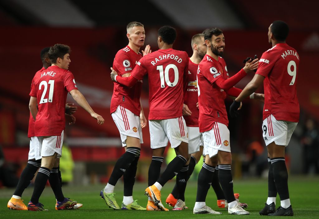 MU MANCHESTER, ENGLAND - DECEMBER 20: Scott McTominay of Manchester United celebrates with team mates (l - r) Marcus Rashford, Bruno Fernandes and Anthony Martial after scoring their sides first goal during the Premier League match between Manchester United and Leeds United at Old Trafford on December 20, 2020 in Manchester, England. The match will be played without fans, behind closed doors as a Covid-19 precaution. (Photo by Nick Potts - Pool/Getty Images)