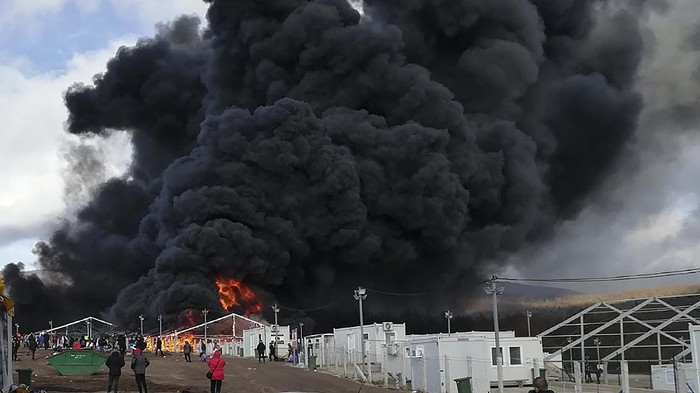 Smoke rises from a fire at migrant camp Lipa, Wednesday, Dec 23, 2020, near Bihac in western Bosnia.  A huge fire has broken out at a migrant camp in northwestern Bosnia which has been in the focus of rights groups because of poor conditions in the tent facility.  Thick black smoke could be seen rising Wednesday from parts of the Lipa camp near the Croatian border which currently houses some 1,200 migrants.  The cause of the fire was not immediately known as migrants were seen running away in panic. There were no reports of injuries. (AP Photo/Hasan Arnautovic)