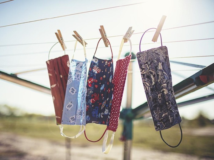 Self-sewn mouth-nose masks against corona viruses hang on the clothesline to dry.