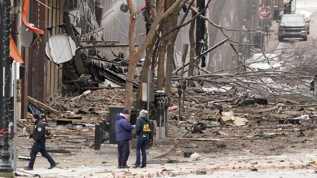 Emergency personnel work near the scene of an explosion in downtown Nashville, Tenn., Friday, Dec. 25, 2020. Buildings shook in the immediate area and beyond after a loud boom was heard early Christmas morning.(AP Photo/Mark Humphrey)