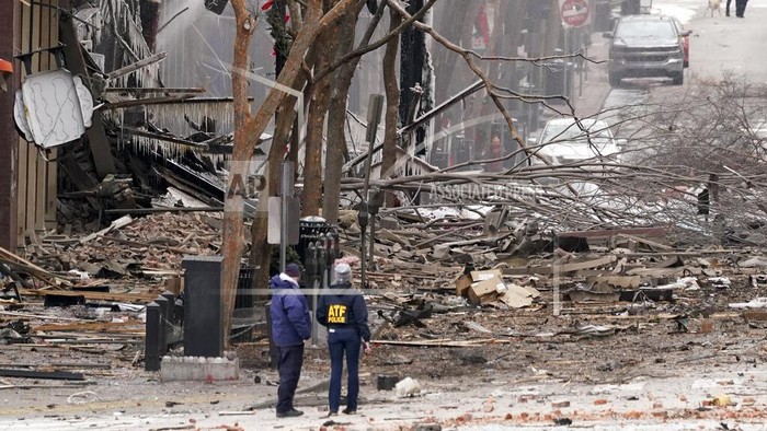 Emergency personnel work near the scene of an explosion in downtown Nashville, Tenn., Friday, Dec. 25, 2020. Buildings shook in the immediate area and beyond after a loud boom was heard early Christmas morning.(AP Photo/Mark Humphrey)