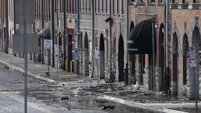 Emergency personnel work near the scene of an explosion in downtown Nashville, Tenn., Friday, Dec. 25, 2020. Buildings shook in the immediate area and beyond after a loud boom was heard early Christmas morning.(AP Photo/Mark Humphrey)