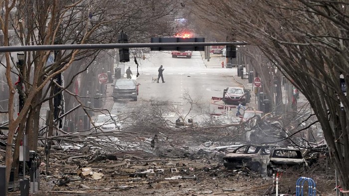 Emergency personnel work near the scene of an explosion in downtown Nashville, Tenn., Friday, Dec. 25, 2020. Buildings shook in the immediate area and beyond after a loud boom was heard early Christmas morning.(AP Photo/Mark Humphrey)
