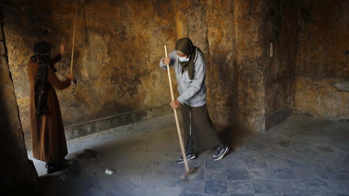 Architects and workers renovate the long-abandoned 200-year-old al-Kamalaia school, in the old quarter of Gaza City, Sunday, Dec. 20, 2020. Less than 200 of these old houses are still partly or entirely standing, according to officials and they are threatened by neglect, decaying and urban sprawl. (AP Photo/Adel Hana)