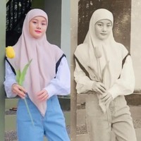 Dalam video yang berdurasi 34 detik itu Dinda Hauw memperlihatkan gaya vintage dengan memakai hijab ala siswi madrasah. Dinda memakai hijab segiempat yang sengaja ia bentuk menutupi sebagian dahinya.Foto: Instagram @dindahw.