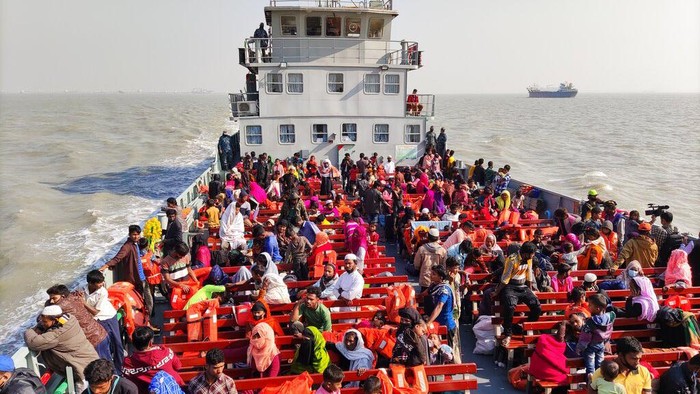 Bangladesh Rohingya Rohingya refugees alight from a naval ship after arriving at Bhashan Char island, in the Bay of Bengal, Bangladesh, Tuesday, Dec. 29, 2020. Officials in Bangladesh sent a second group of Rohingya refugees to the island on Monday despite calls by human rights groups for a halt to the process. Seven Bangladesh navy ships carrying 1,804 Rohingya refugees arrived Tuesday at an isolated island where they will be relocated despite concerns among human rights groups about their safety. Authorities say the refugees were selected for relocation based on their willingness, and that no pressure was applied on them. But several human rights and activist groups say some refugees have been forced to go to the island, located 21 miles (34 kilometers) from the mainland. (AP Photo/Mahmud Hossain Opu)