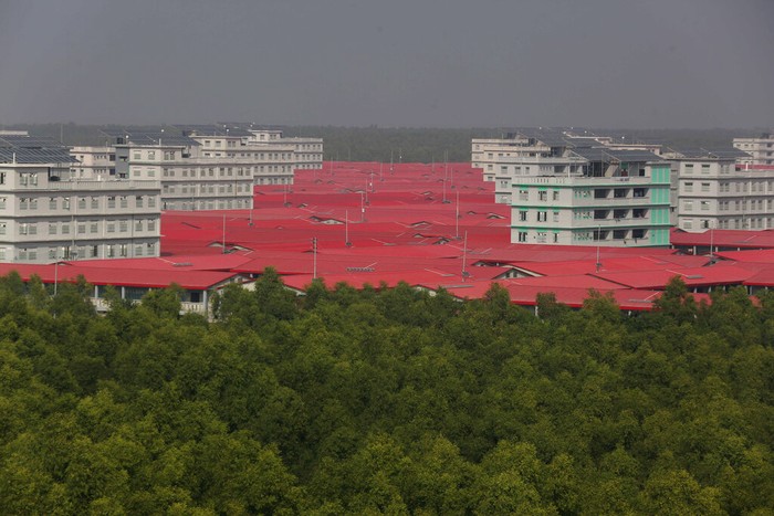 Rohingya refugees alight from a naval ship after arriving at Bhashan Char island, in the Bay of Bengal, Bangladesh, Tuesday, Dec. 29, 2020. Officials in Bangladesh sent a second group of Rohingya refugees to the island on Monday despite calls by human rights groups for a halt to the process. Seven Bangladesh navy ships carrying 1,804 Rohingya refugees arrived Tuesday at an isolated island where they will be relocated despite concerns among human rights groups about their safety. Authorities say the refugees were selected for relocation based on their willingness, and that no pressure was applied on them. But several human rights and activist groups say some refugees have been forced to go to the island, located 21 miles (34 kilometers) from the mainland. (AP Photo/Mahmud Hossain Opu)