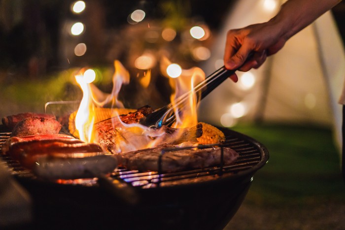 BBQ Family making barbecue in dinner party camping at night