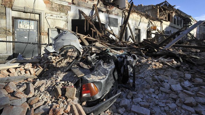 A man stands amidst the rubble from buildings damaged in an earthquake in Petrinja, Croatia, Tuesday, Dec. 29, 2020. A strong earthquake has hit central Croatia and caused major damage and at least one death and some 20 injuries in the town southeast of the capital Zagreb. (AP Photo)