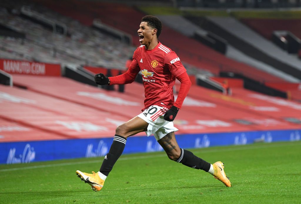 Marcus Rashford MANCHESTER, ENGLAND - DECEMBER 29: Marcus Rashford of Manchester United celebrates after scoring his team's first goal during the Premier League match between Manchester United and Wolverhampton Wanderers at Old Trafford on December 29, 2020 in Manchester, England. The match will be played without fans, behind closed doors as a Covid-19 precaution. (Photo by Michael Regan/Getty Images)