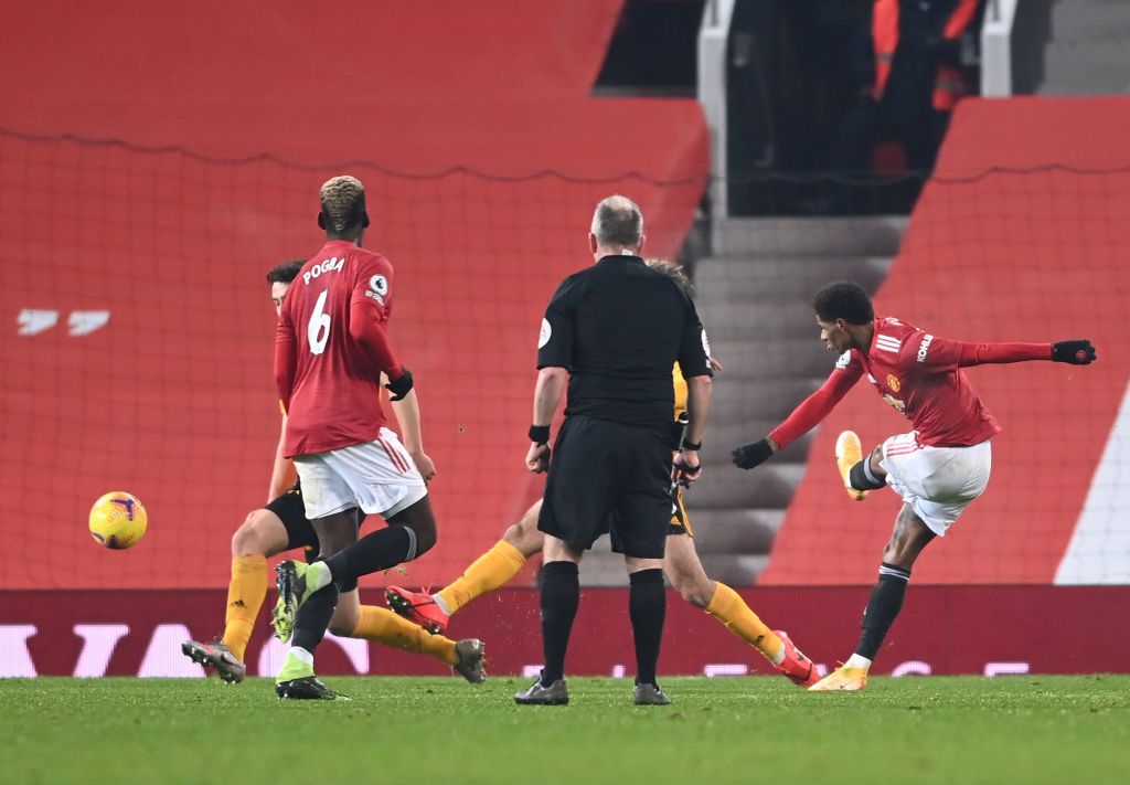 MANCHESTER, ENGLAND - DECEMBER 29: Marcus Rashford of Manchester United celebrates with teammate Paul Pogba after scoring his team's first goal during the Premier League match between Manchester United and Wolverhampton Wanderers at Old Trafford on December 29, 2020 in Manchester, England. The match will be played without fans, behind closed doors as a Covid-19 precaution. (Photo by Michael Regan/Getty Images)