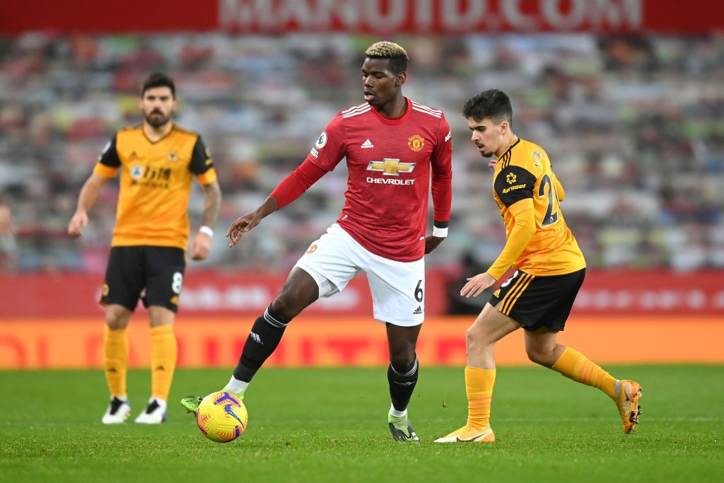 MU Vs Wolves MANCHESTER, ENGLAND - DECEMBER 29: Paul Pogba of Manchester United controls the ball under pressure from Vitinha of Wolverhampton Wanderers during the Premier League match between Manchester United and Wolverhampton Wanderers at Old Trafford on December 29, 2020 in Manchester, England. The match will be played without fans, behind closed doors as a Covid-19 precaution. (Photo by Michael Regan/Getty Images)
