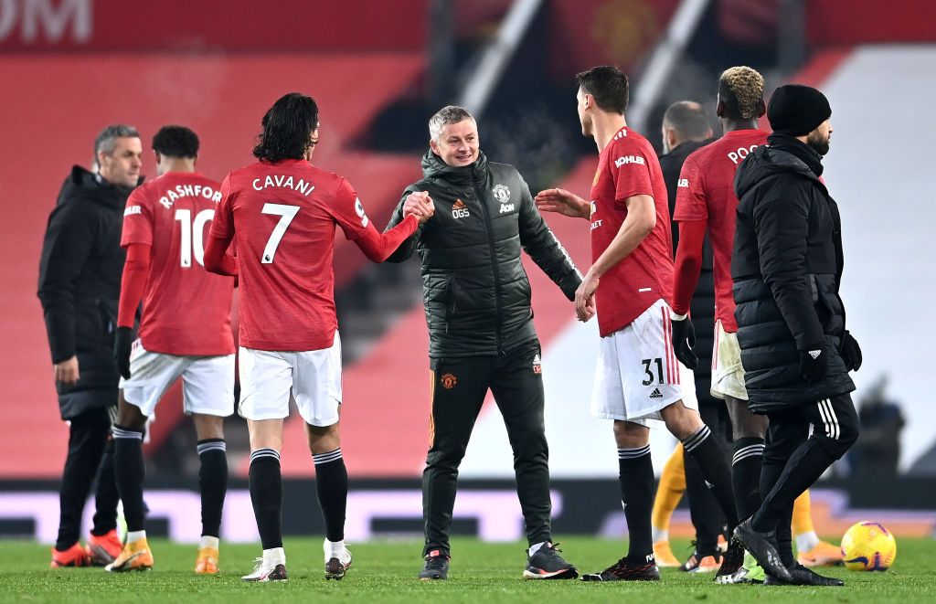 Ole Gunnar Solskjaer MANCHESTER, ENGLAND - DECEMBER 29: Ole Gunnar Solskjaer, Manager of Manchester United, Edinson Cavani, and Nemanja Matic celebrate following their team's victory in the Premier League match between Manchester United and Wolverhampton Wanderers at Old Trafford on December 29, 2020 in Manchester, England. The match will be played without fans, behind closed doors as a Covid-19 precaution. (Photo by Laurence Griffiths/Getty Images)