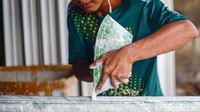 Pekerja menyelesaikan pembuatan list gypsum.