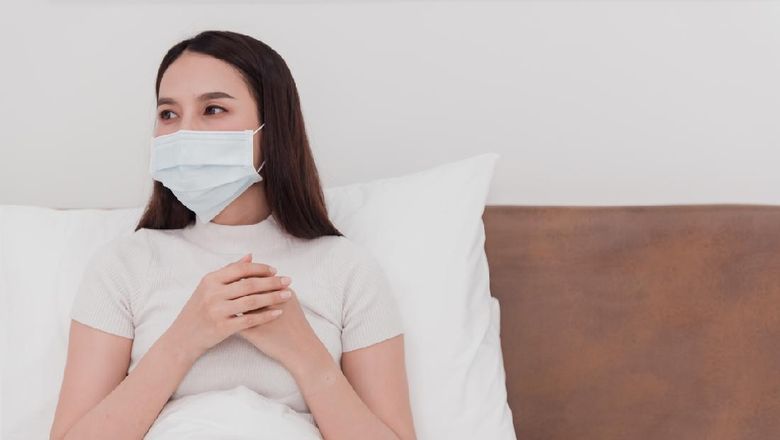 Asian woman wearing mask, sick doctor, cough, use to grasp the chest in the bedroom