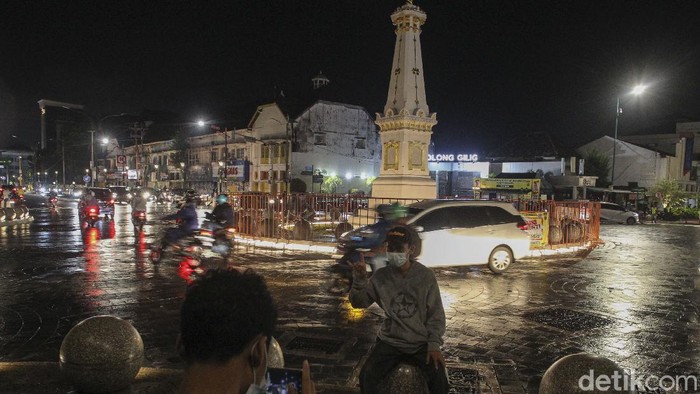 Petugas gabungan dari Kepolisian dan Satuan Polisi Pamong Praja berjaga pada malam pergantian tahun di simpang empat Tugu Pal Putih, Yogyakarta, Kamis (31/12/2020). Pemerintah Daerah Istimewa Yogyakarta (Pemda DIY) menutup tempat wisata saat malam pergantian tahun. Penutupan itu menyasar empat kabupaten di DIY. Penutupan itu tertuang dalam surat nomor 443/03734 tentang penutupan objek wisata pada malam pergantian tahun baru. Surat tertanggal 31 Desember yang diteken Sekda DIY Kadarmanta Baskara Aji ini ditujukan ke Bupati Sleman, Bupati Bantul, Bupati Gunungkidul dan Bupati Kulonprogo. detikcom/Pius Erlangga