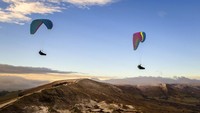 Para penerbang paraglider juga memanfaatkan musim dingin untuk terbang di atas Mam Tor, bukit setinggi 517m dekat Castleton di Inggris tengah. Danny Lawson/PA via AP  