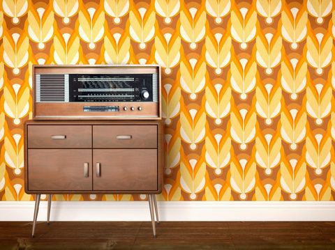 kesalahan desain interior Vintage old radio from eastern Europe (labels indicate cities of the eastern block, including former GDR, East Germany) laying on a piece of furniture and a background showing a sixties, seventies design wallpaper pattern. Copy space on the side for customization.