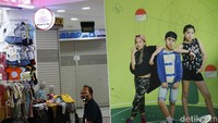 Seorang pedagang menunggu pembeli dengan duduk santai di depan kiosnya.