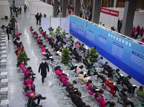 In this photo released by Xinhua News Agency, residents wait for 30 minutes at an observation point after receiving their COVID-19 vaccinations at a temporary vaccination site in Beijing, Saturday, Jan. 2, 2021. China authorized its first homegrown COVID-19 vaccine for general use on Dec. 31, 2020, adding another shot that could see wide use in poorer countries as the virus surges back around the globe. (Chen Zhonghao/Xinhua via AP)