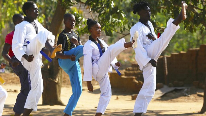 Natsiraishe Maritsa shows some of her taekwondo medals at her home in the Epworth settlement about 15 km southeast of the capital Harare, Saturday Nov. 7, 2020. In Zimbabwe, where girls as young as 10 are forced to marry due to poverty or traditional and religious practices, a teenage martial arts fan 17-year old Natsiraishe Maritsa is using the sport to give girls in an impoverished community a fighting chance at life. (AP Photo/Tsvangirayi Mukwazhi)