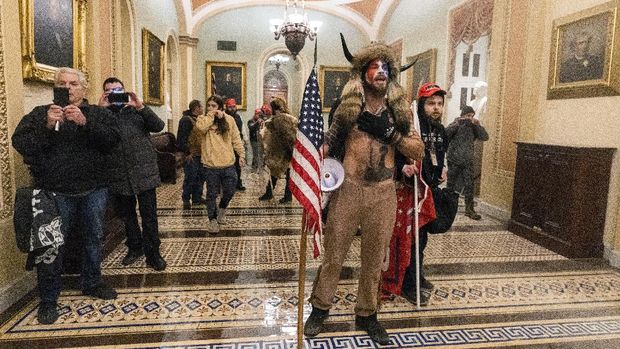 Supporters of President Donald Trump are confronted by Capitol Police officers outside the Senate Chamber inside the Capitol, Wednesday, Jan. 6, 2021 in Washington. (AP Photo/Manuel Balce Ceneta)