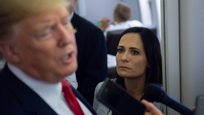 White House Press Secretary Stephanie Grisham listens as US President Donald Trump speaks to the media aboard Air Force One while flying between El Paso, Texas and Joint Base Andrews in Maryland, August 7, 2019. (Photo by SAUL LOEB / AFP)
