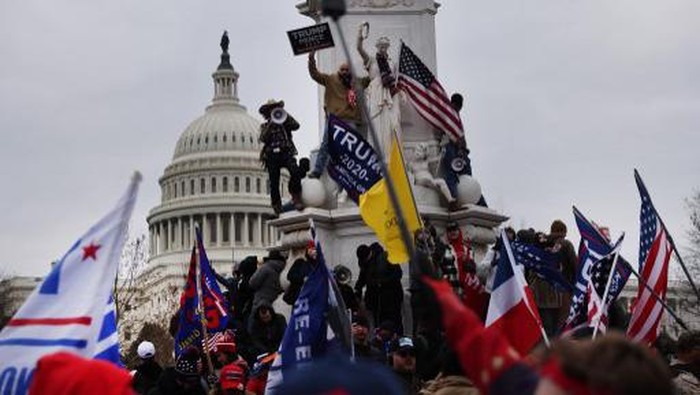 WASHINGTON, DC - JANUARY 06: Protesters gather on the U.S. Capitol Building on January 06, 2021 in Washington, DC. Pro-Trump protesters entered the U.S. Capitol building after mass demonstrations in the nations capital during a joint session Congress to ratify President-elect Joe Bidens 306-232 Electoral College win over President Donald Trump.   Tasos Katopodis/Getty Images/AFP