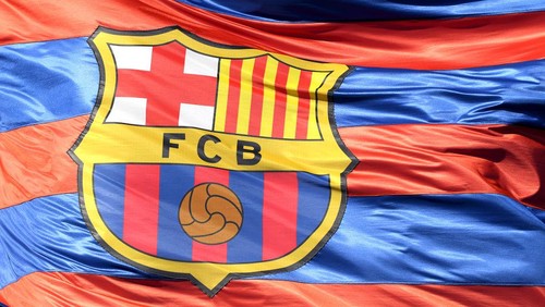 BARCELONA, SPAIN - APRIL 04:  The Barcelona logo is seen on a flag waving above the stadium prior to the UEFA Champions League Quarter Final Leg One match between FC Barcelona and AS Roma at Camp Nou on April 4, 2018 in Barcelona, Spain.  (Photo by Mike Hewitt/Getty Images)
