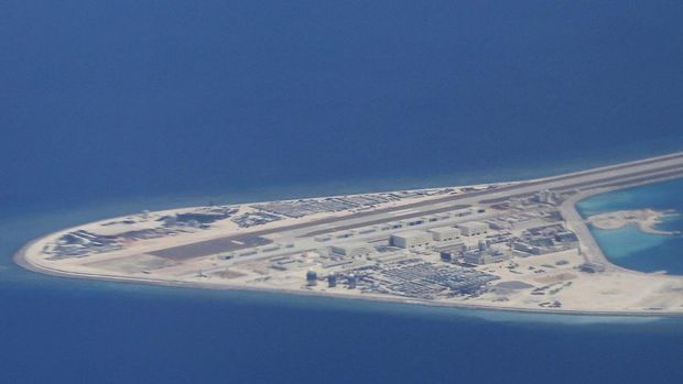 South China Sea Watch FILE - In this Friday, April 21, 2017, file photo, an airstrip, structures and buildings on China's man-made Subi Reef in the Spratly chain of islands in the South China Sea are seen from a Philippine Air Force C-130 transport plane of the Philippine Air Force. (AP Photo/Bullit Marquez, File)