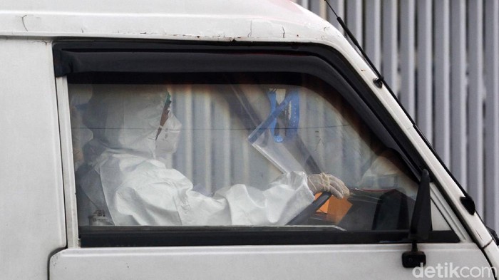 Potret Ambulans Bersliweran Bawa Pasien Corona ke Wisma Atlet Para tenaga kesehatan dengan baju hazmat dan peralatan lengkap membawa pasien menggunakan mobil ambulans ke Rumah Sakit Darurat Penanganan COVID-19 (RSDP) Wisma Atlet, Jakarta, Sabtu (9/1/2021).