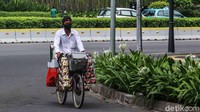 Pedagang kopi keliling melintas di kawasan Thamrin yang terpantau sepi.