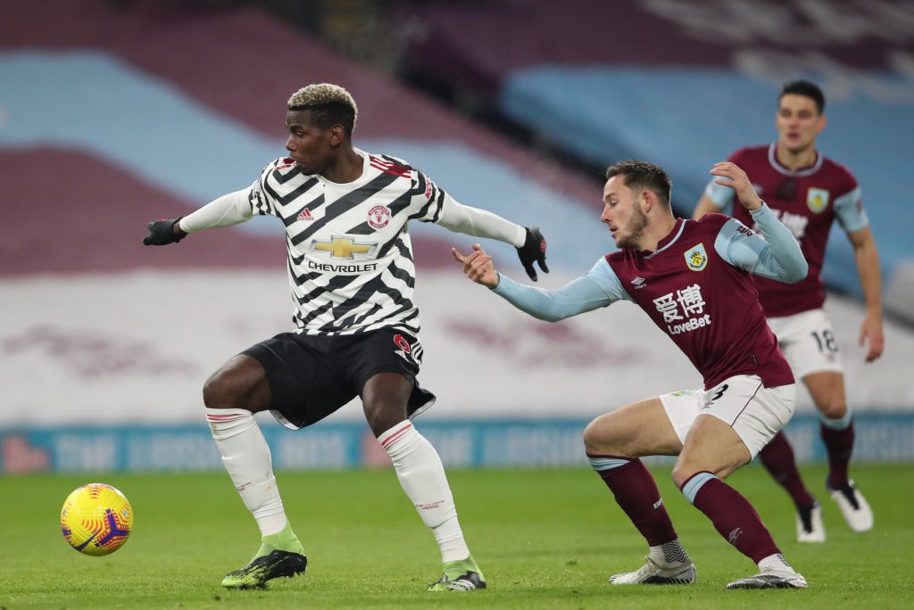 BURNLEY, ENGLAND - JANUARY 12: Paul Pogba of Manchester United is challenged by Josh Brownhill of Burnley during the Premier League match between Burnley and Manchester United at Turf Moor on January 12, 2021 in Burnley, England. Sporting stadiums around England remain under strict restrictions due to the Coronavirus Pandemic as Government social distancing laws prohibit fans inside venues resulting in games being played behind closed doors. (Photo by Clive Brunskill/Getty Images)