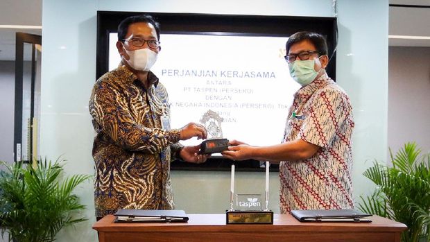 Direktur Hubungan Kelembagaan BNI Sis Apik Wijayanto (kiri) dan Direktur Keuangan Taspen Patar Sitanggang (kanan) menandatangani Perjanjian Kerjasama Kustodian di Jakarta, (15 Januari 2021). BNI mendapatkan kepercayaan menjadi pemberi jasa kustodian untuk mengelola asset-aset Taspen. Asset Under Custody (AUC) BNI per bulan Desember 2020 mencapai Rp 270,5 triliun dengan total nasabah mencapai lebih dari 200 institusi. 9Dok. BNI)