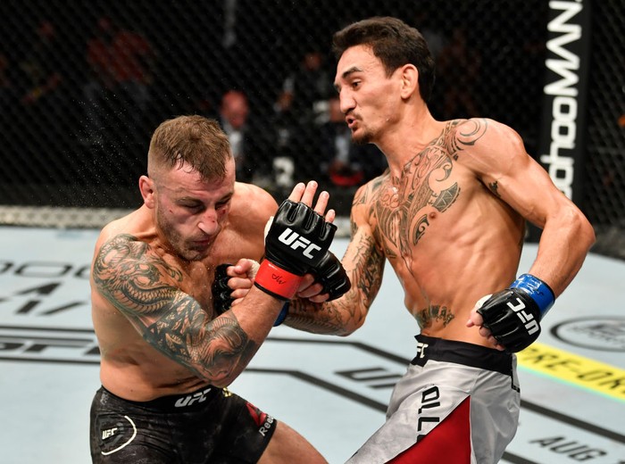 ABU DHABI, UNITED ARAB EMIRATES - JULY 12: In this handout image provided by UFC, (R-L) Max Holloway punches Alexander Volkanovski of Australia in their UFC featherweight championship fight during the UFC 251 event at Flash Forum on UFC Fight Island on July 12, 2020 on Yas Island, Abu Dhabi, United Arab Emirates. (Photo by Jeff Bottari/Zuffa LLC via Getty Images)